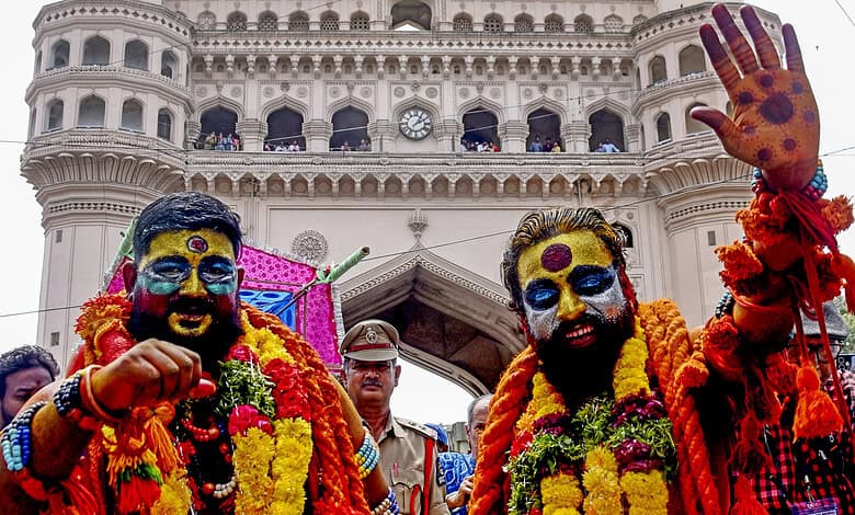 Two men with colourful face paint and flower garlands celebrate at Hyderabad Old City Bonalu festival.Hyderabad Old City Bonalu festival to conclude today