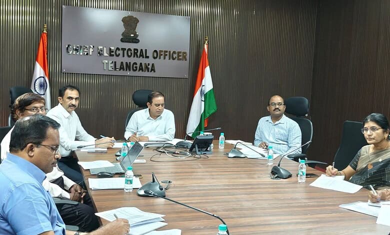 Election officials and staff seated at a conference table during a meeting at Telangana's Chief Electoral.