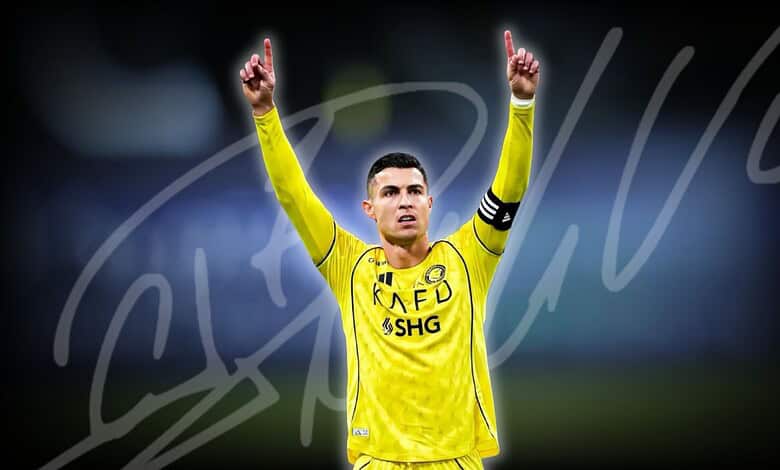 Cristiano Ronaldo in yellow football kit celebrating with arms raised during match.