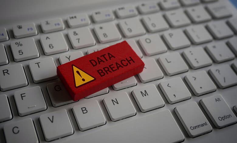 Red warning key with 'Data Breach' on a computer keyboard.