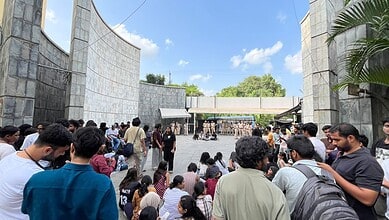 Students gather outside the EFLU campus after the clash.