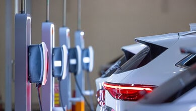 Electric vehicle charging station with multiple cars being charged in Telangana, India.
