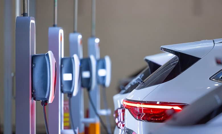 Electric vehicle charging station with multiple cars being charged in Telangana, India.