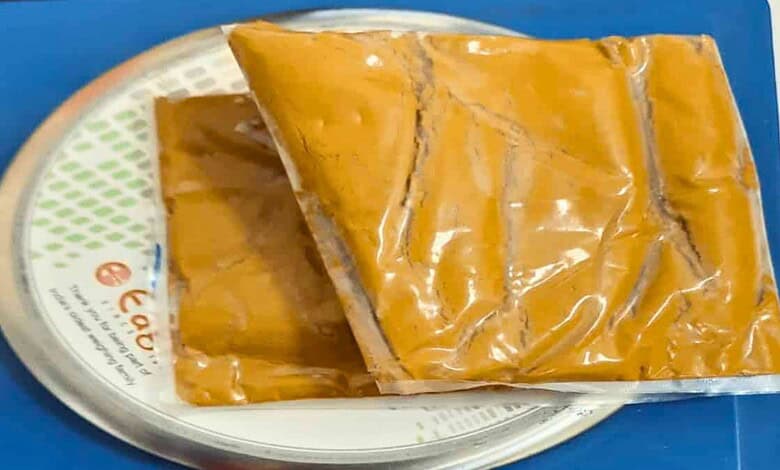 Sealed package of gold bars on a weighing scale at RGIA airport.