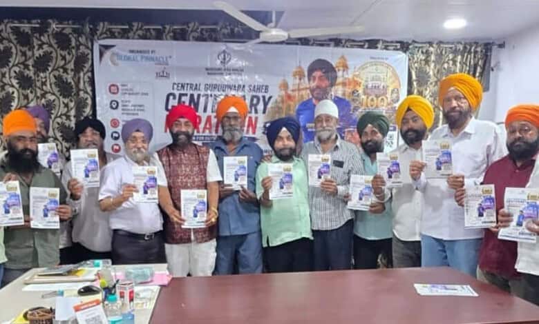 Group of people holding flyers during Gowliguda Gurudwara's centenary event in Hyderabad.