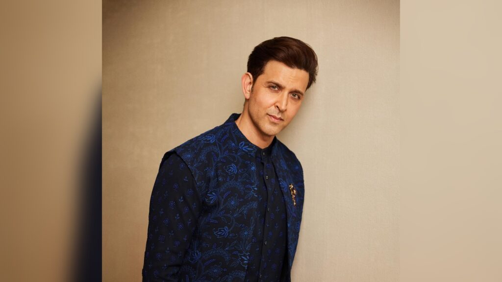 Hrithik Roshan wearing a blue traditional outfit, posing against a plain background.