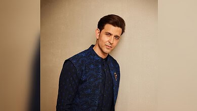 Hrithik Roshan wearing a blue traditional outfit, posing against a plain background.