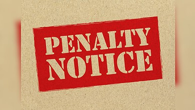 Penalty notice on a beige background with bold red text.