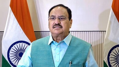 Nadda meets reservation protestors with Indian flags in the background.