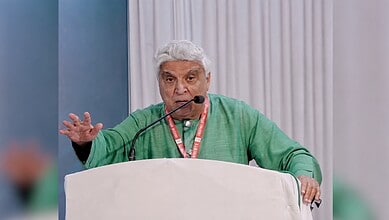 Javed Akhtar speaking passionately at a public event with a microphone.