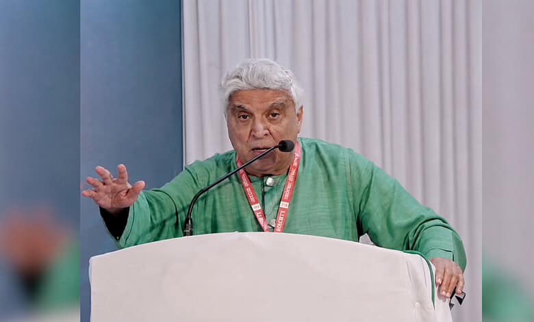 Javed Akhtar speaking passionately at a public event with a microphone.