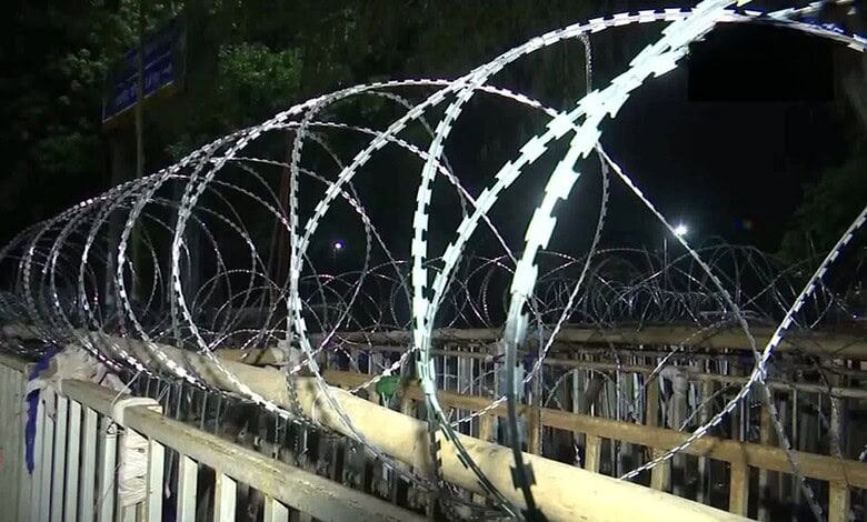Barbed wire fencing along a barricade for security during protests in Jharkhand.