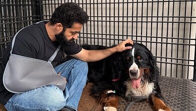Jr NTR with his beloved pet Bagheera in a cage, showing affection and companionship.