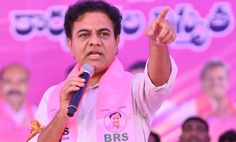 KTR speaking passionately at a public event with a pink backdrop and supporters.