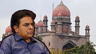 K. T. Rama Rao (KTR) in front of historic red sandstone building with domes and minarets.