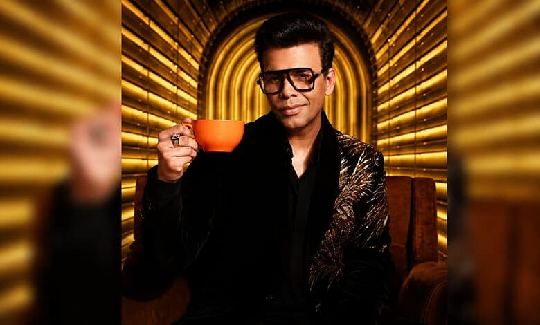 Aamir Khan in stylish black outfit holding an orange cup on Koffee With Karan 9 set.