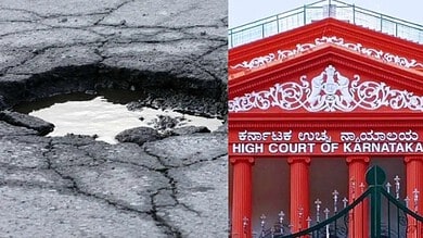Close-up of a large pothole on a cracked road surface with water inside.