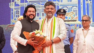 Karnataka minister Nagendra with supporters and police at a public event.