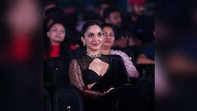 Kiara Advani attending an event in a black saree with lace sleeves and a choker necklace.