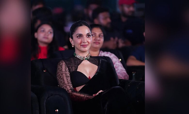 Kiara Advani attending an event in a black saree with lace sleeves and a choker necklace.