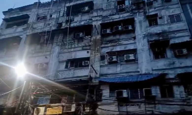 Burnt building facade after fire in Kolkata hotel, with damaged windows and charred exterior.