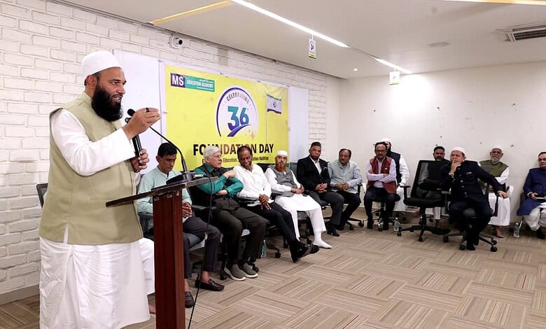 Religious leader speaking at a seminar with an audience in a modern conference room.