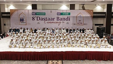 Group of children in white traditional attire at MS Hifz Academy's eighth Dastarbandi ceremony.