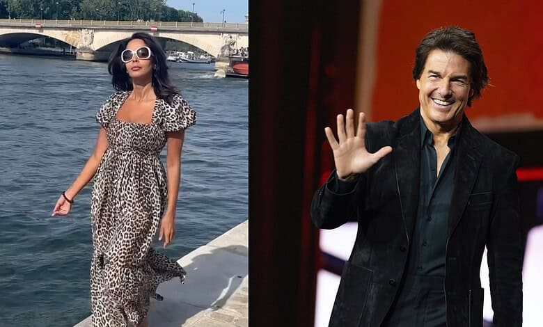 Mallika Sherawat in a leopard print dress by the river, wearing sunglasses and walking along the water.