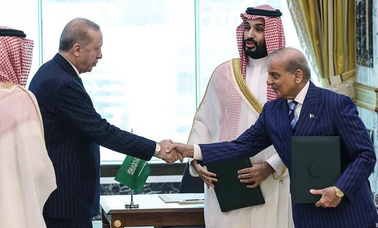 Leaders from India and Saudi Arabia shake hands during a formal meeting.