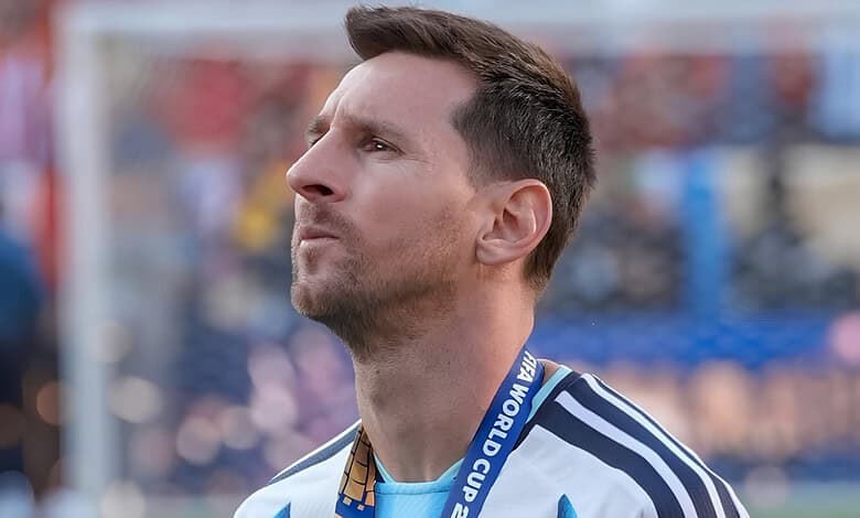 Lionel Messi wearing a World Cup medal and a blue and white jersey, celebrating his victory.