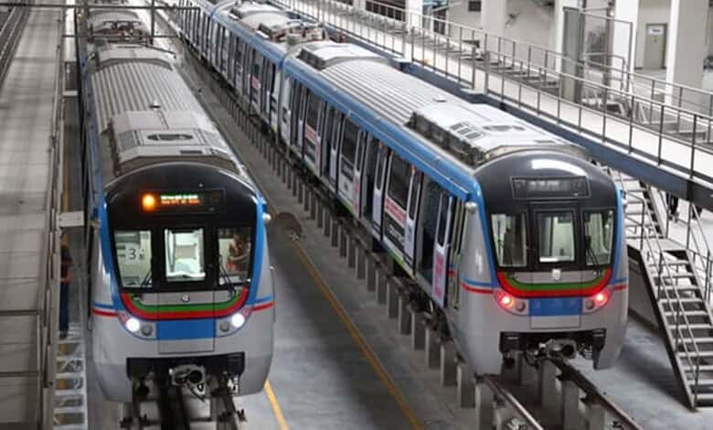 Modern Hyderabad metro trains on elevated tracks in a station.