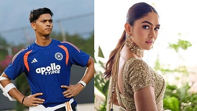 Cricketer in blue jersey with hands on hips, woman in gold dress with earrings, outdoor setting.