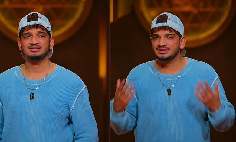 Young man in blue sweater and cap speaking emotionally on stage at The Siasat Daily event.