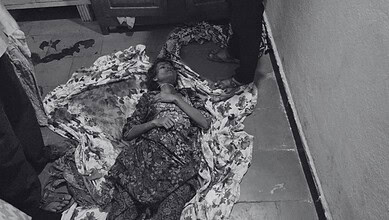 Young woman lying dead on the floor with floral bedsheet in Balapur, Hyderabad.