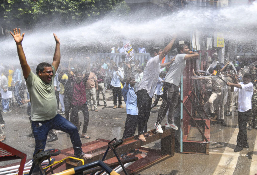 Protesters clash with police as water cannons are used during demonstration at CM house.