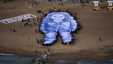 People hold a giant portrait of Hind Rajab, a five-year-old Palestinian girl who was killed during the war in Gaza, on a beach in Barcelona, Spain, Thursday, January 29, 2026.