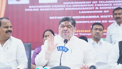 Telangana government official speaking at a press conference about knitting machines distribution.