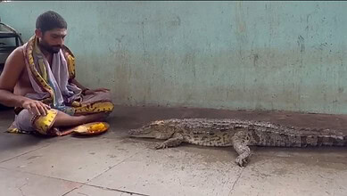 Priest worships crocodile
