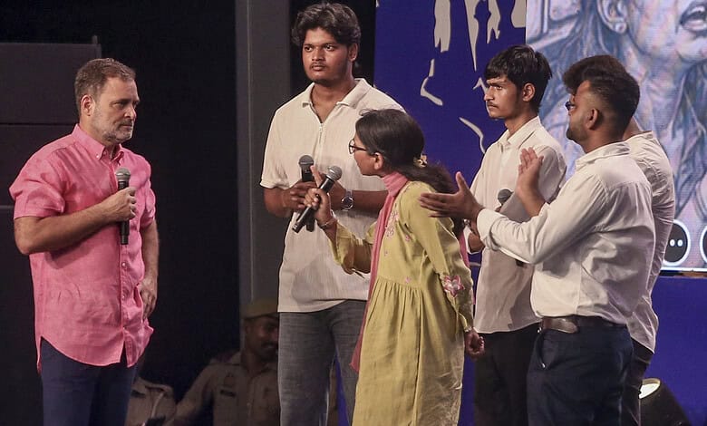 Rahul Gandhi interacts with young students during a public event in India.