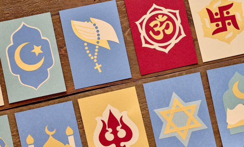 Collection of various religious symbols on colourful cards, representing different faiths.