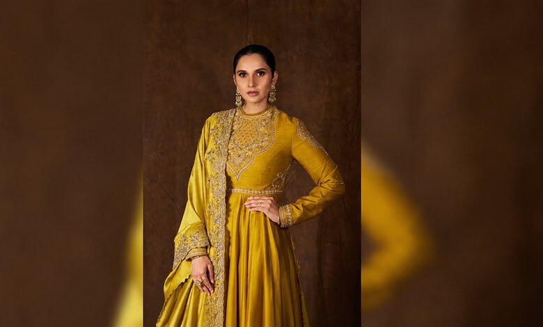 Sania Mirza in a yellow traditional outfit with intricate embroidery and jewelry.