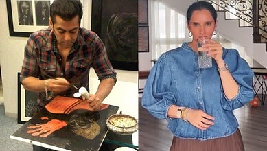 Sania Mirza enjoying her art collection at her Dubai home with a glass of water.