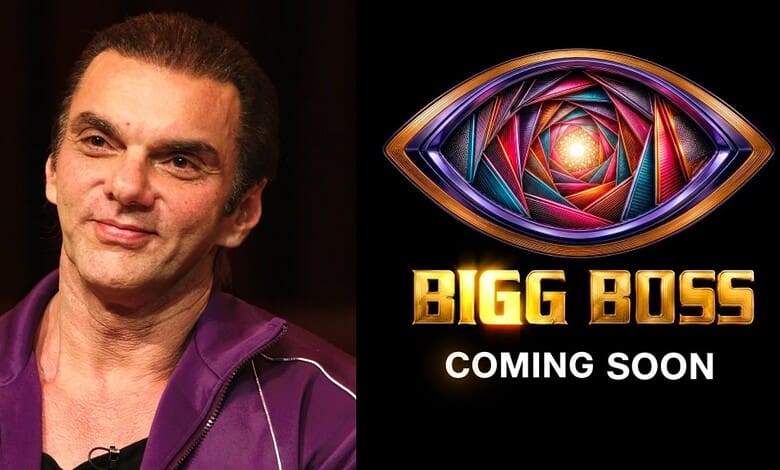 Sohail Khan in a purple jacket, promoting Bigg Boss with a colourful eye logo.