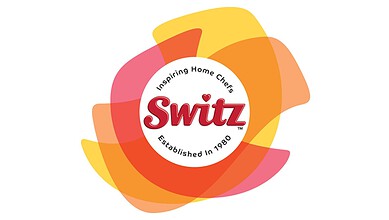 Switz Foods logo with colourful abstract background, inspiring home chefs since 1980.