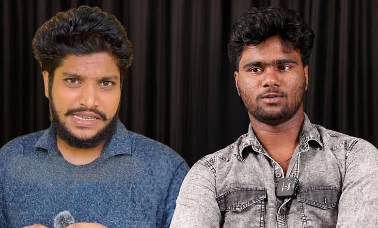 Two young men speaking at a press conference with a black curtain backdrop.