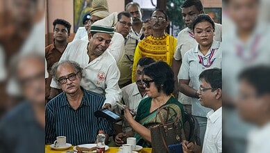 Exiled Bangladeshi author Taslima Nasrin attempts to make a digital payment during her visit to the historic College Street Coffee House, in Kolkata, West Bengal, Monday, Aug. 3, 2026. (PTI Photo/Manvender Vashist Lav)
