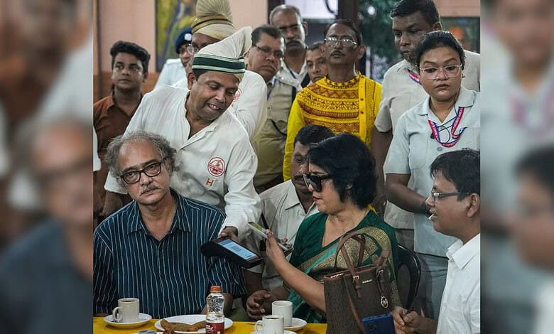 Exiled Bangladeshi author Taslima Nasrin attempts to make a digital payment during her visit to the historic College Street Coffee House, in Kolkata, West Bengal, Monday, Aug. 3, 2026. (PTI Photo/Manvender Vashist Lav)