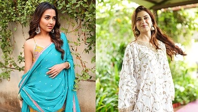 Tejasswi Prakash in a blue saree with traditional jewelry, posing outdoors with greenery in the backdrop.