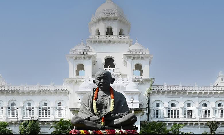 Statue of Mahatma Gandhi in front of a historic white building in India.