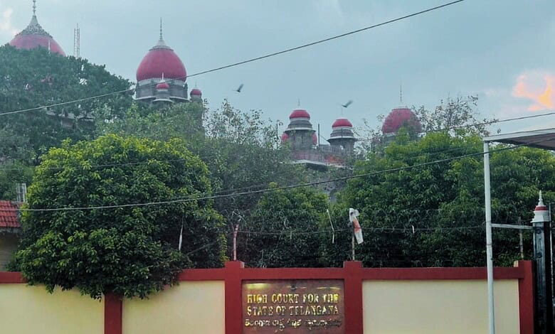 Historical building with red domes and lush greenery in front, under a cloudy sky.